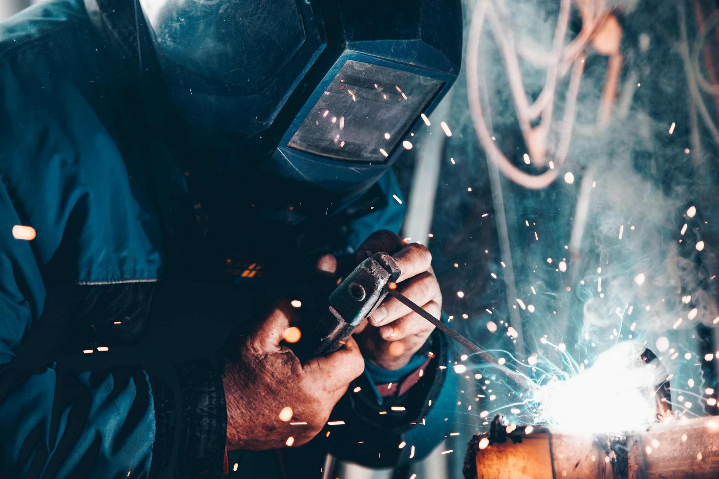 Sparks fly as a Chebez technician works molten metal on the production floor